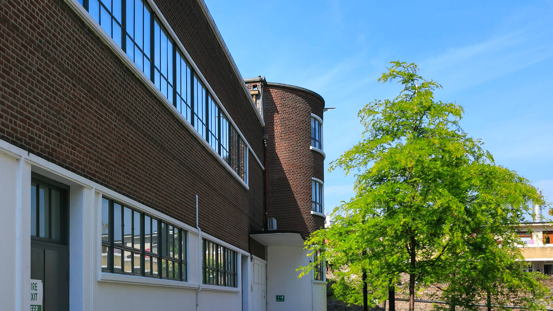 Lines of glass windows against the brick of the Digital Depot building exterior