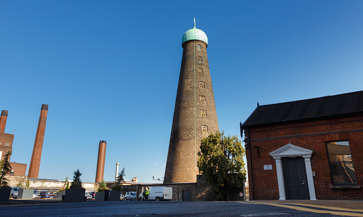 St Patrick's Tower stands against the blue sky above The Digital Hub campus in Dublin.