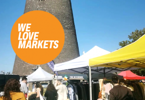 Brightly coloured market stalls at a flea market on a sunny day