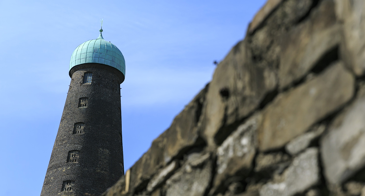 St Patrick's Tower stands in front of a blue sky at The Digital Hub, Dublin.