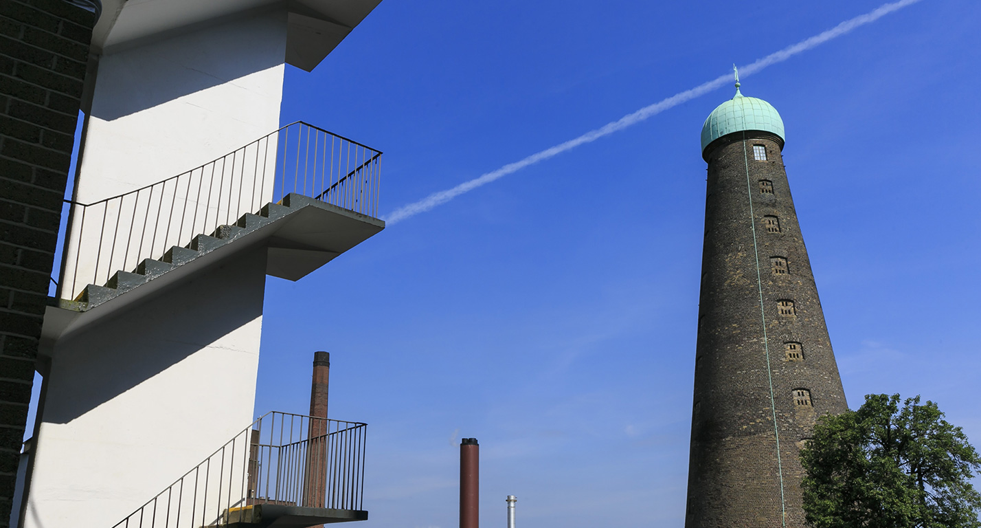 St Patrick's Tower stands against a blue sky with the staircase of the OneFiveSeven building in the foreground.