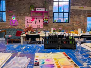 Picture of Block T event space, with chairs tables and multicoloured walls.